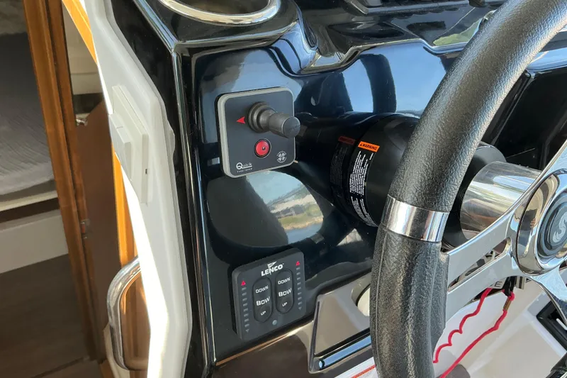 Slide: The Image of Helm controls of a 2022 Beneteau Antares 9 boat, featuring steering wheel and switches. - 37