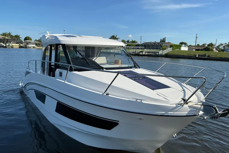 Slide: The Image of 2022 Beneteau Antares 9 boat on calm water, showcasing sleek design and modern features. - 38