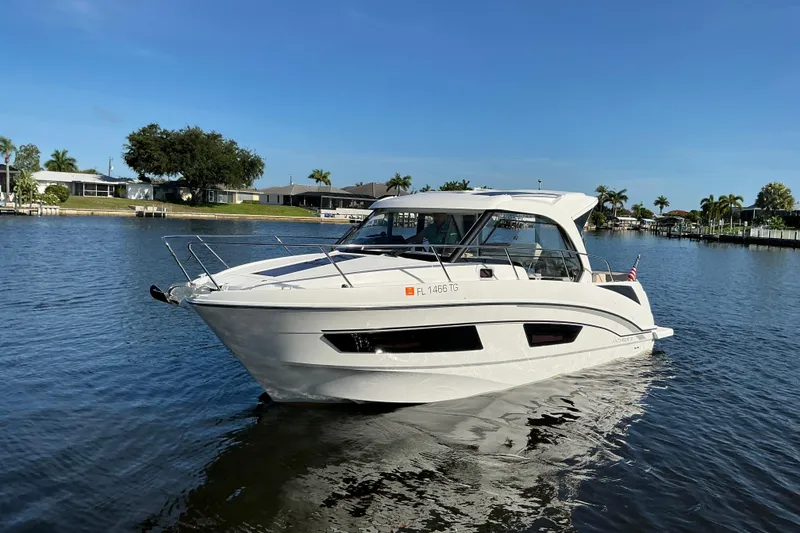 Slide: The Image of 2022 Beneteau Antares 9 boat cruising on a sunny day in a calm waterway. - 40