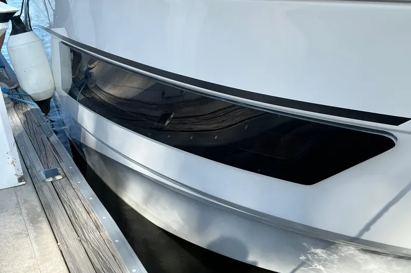 Slide: The Image of 2022 Beneteau Antares 9 docked, showcasing sleek hull design and modern window features. - 49