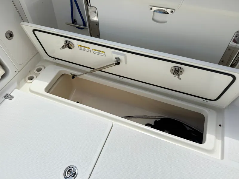 Slide: The Image of Storage compartment on a 2016 Boston Whaler 285 Conquest boat. - 14