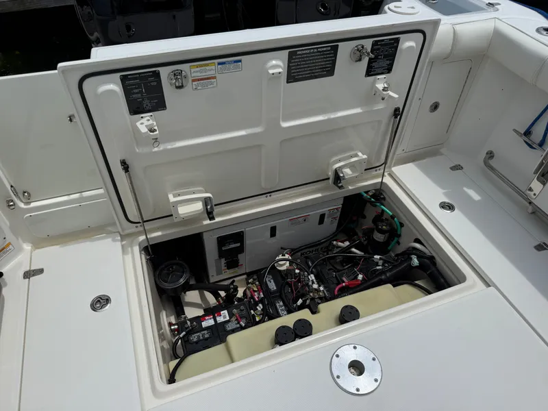 Slide: The Image of Engine compartment of 2016 Boston Whaler 285 Conquest with open hatch. - 17