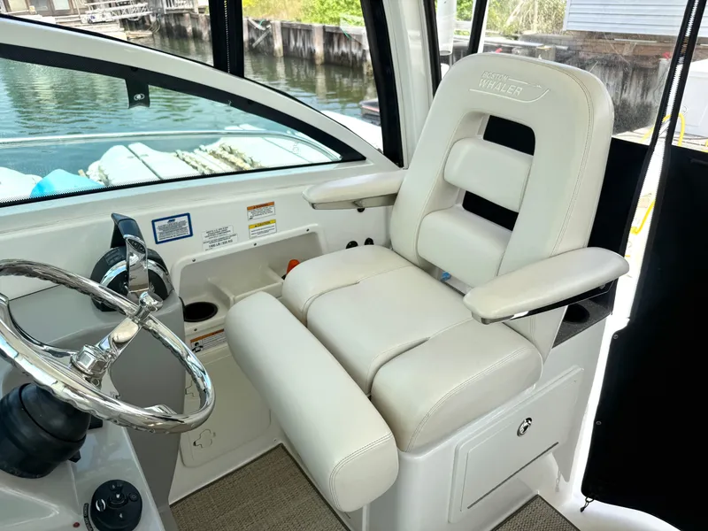 Slide: The Image of 2016 Boston Whaler 285 Conquest helm with luxurious captain's chair. - 26