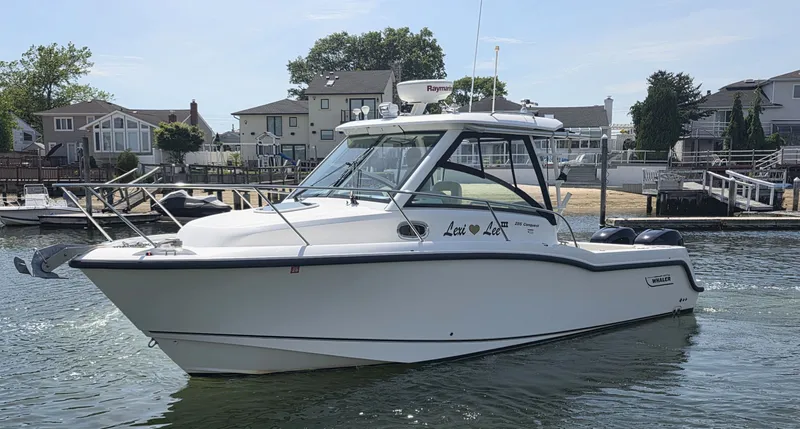Slide: The Image of 2016 Boston Whaler 285 Conquest boat on water, side view. - 3