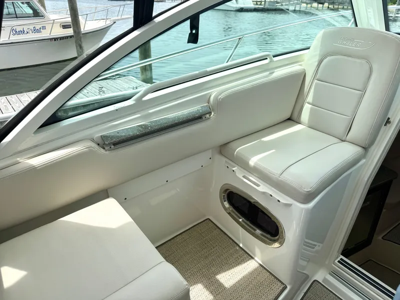 Slide: The Image of Interior of 2016 Boston Whaler 285 Conquest with beige seating area. - 30