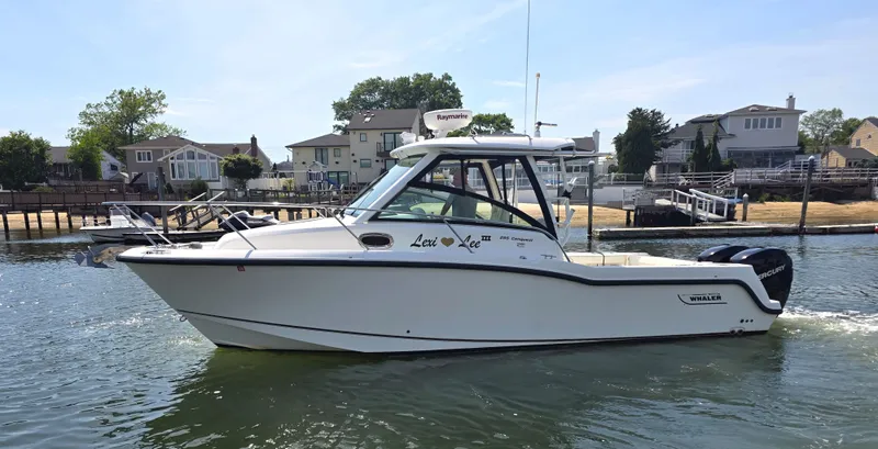 Slide: The Image of 2016 Boston Whaler 285 Conquest boat on water, side view. - 4