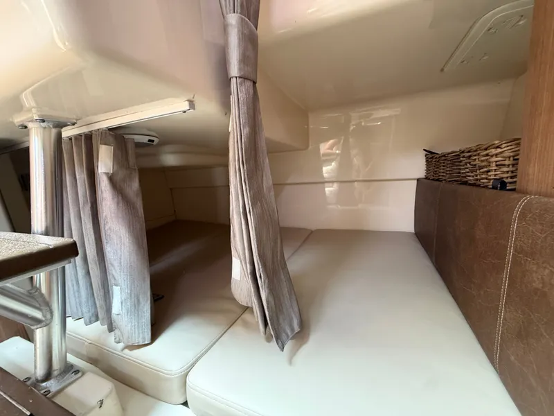 Slide: The Image of Interior of 2016 Boston Whaler 285 Conquest with curtains and seating area. - 40
