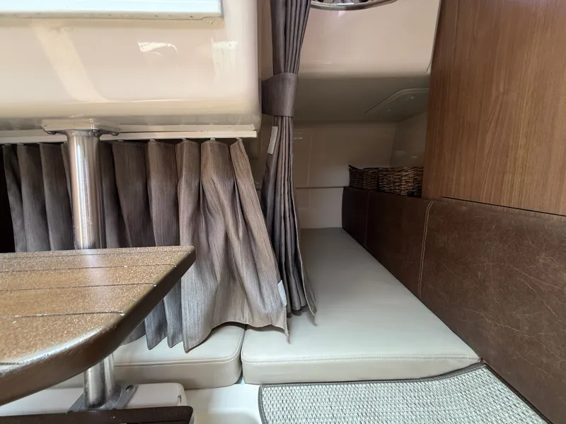 Slide: The Image of Interior of 2016 Boston Whaler 285 Conquest with curtains and seating area. - 42