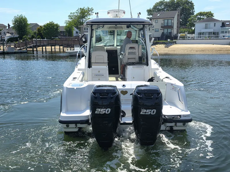 Slide: The Image of 2016 Boston Whaler 285 Conquest with twin outboard engines on water. - 5