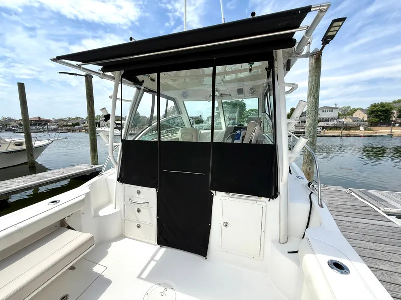 Slide: The Image of 2016 Boston Whaler 285 Conquest at dock with black canopy. - 9