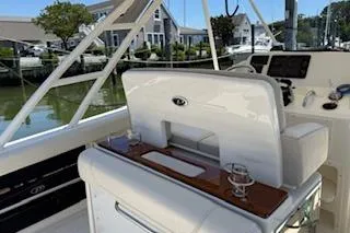 Slide: The Image of 2014 Pursuit S 280 Sport boat interior with helm and seating area. - 10