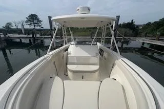 Slide: The Image of 2014 Pursuit S 280 Sport boat docked, showcasing spacious seating and sleek design. - 14