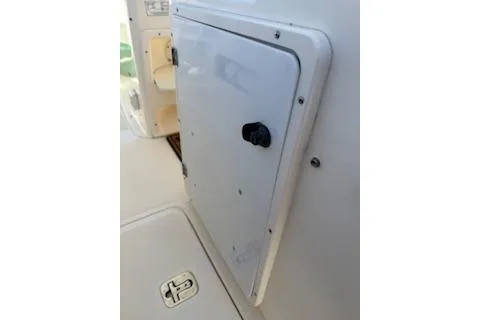 Slide: The Image of 2014 Pursuit S 280 Sport boat compartment door with latch, white finish. - 16