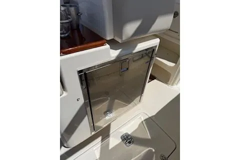 Slide: The Image of 2014 Pursuit S 280 Sport boat interior with stainless steel storage compartment. - 17