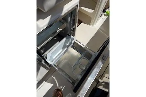 Slide: The Image of Open storage compartment on 2014 Pursuit S 280 Sport boat. - 18