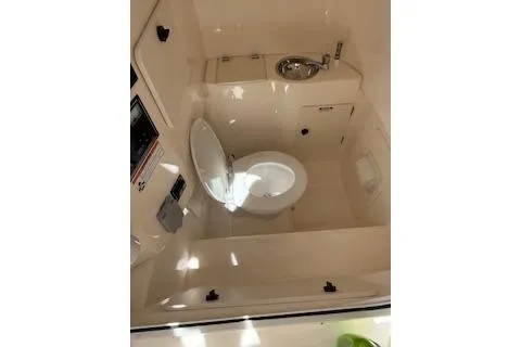 Slide: The Image of 2014 Pursuit S 280 Sport boat interior with toilet and sink. - 19