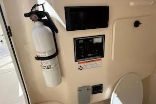 Slide: The Image of 2014 Pursuit S 280 Sport boat interior with fire extinguisher and control panel. - 20