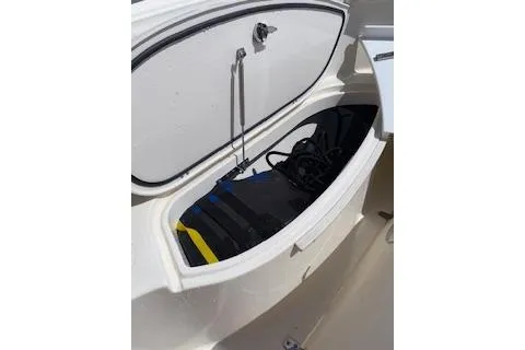 Slide: The Image of Storage compartment on a 2014 Pursuit S 280 Sport boat, open with gear inside. - 22