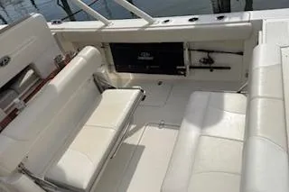 Slide: The Image of 2014 Pursuit S 280 Sport boat interior with white seating and storage compartments. - 26
