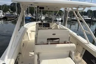 Slide: The Image of 2014 Pursuit S 280 Sport boat docked at a marina, showcasing its spacious interior. - 8