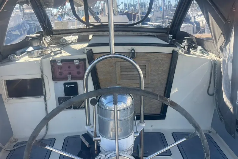 Slide: The Image of Cockpit of a 1971 Santana 37 sailboat with steering wheel and navigation equipment. - 10