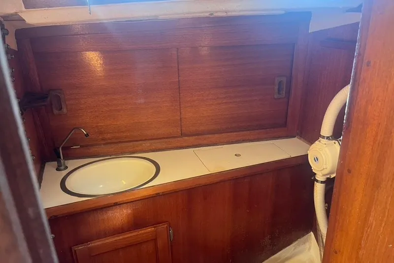 Slide: The Image of 1971 Santana 37 yacht interior with wooden cabinetry and sink. - 13