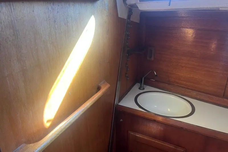 Slide: The Image of 1971 Santana 37 yacht interior with wooden cabinetry and sink. - 14