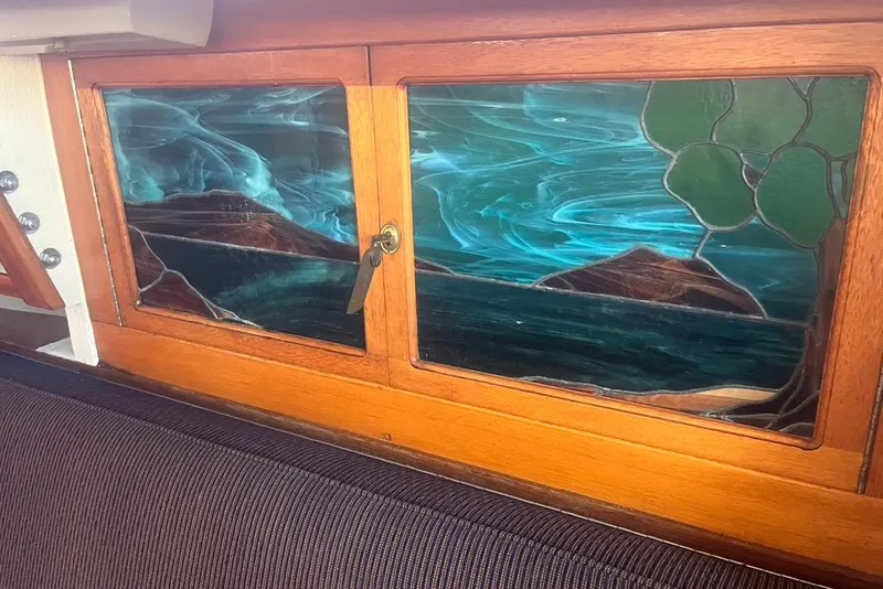 Slide: The Image of Stained glass artwork on 1971 Santana 37 yacht, depicting a serene ocean landscape. - 15