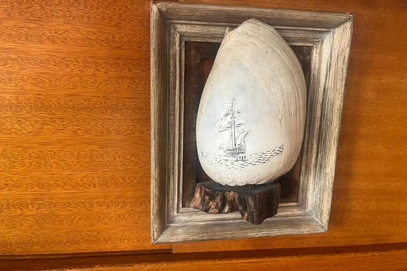 Slide: The Image of Framed shell art with ship engraving on Santana 37, 1971 wooden interior. - 16