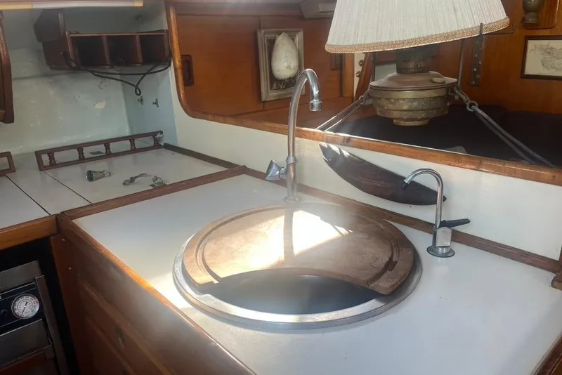 Slide: The Image of 1971 Santana 37 yacht interior with wooden cabinetry and round sink. - 18