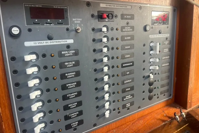 Slide: The Image of Electrical panel of a 1971 Santana 37 sailboat, featuring various switches and controls. - 19
