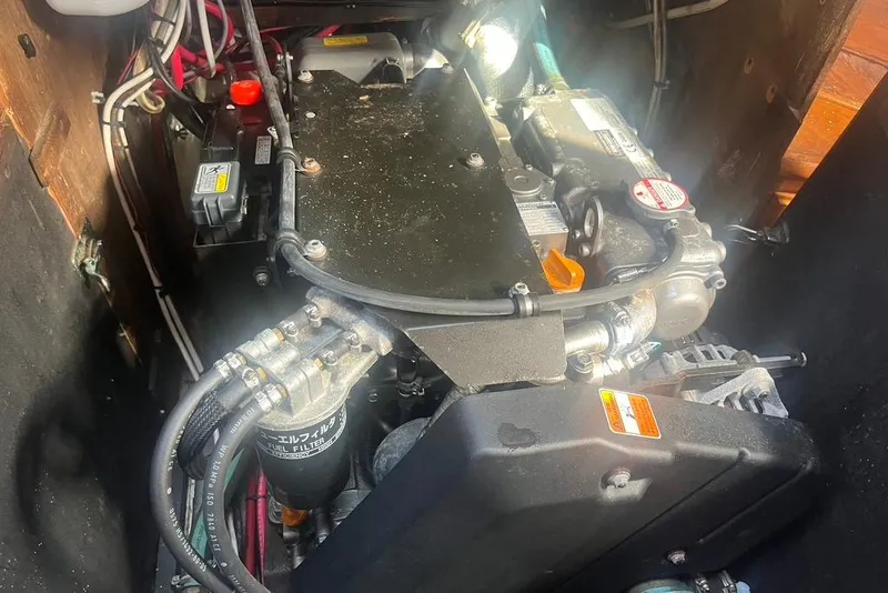 Slide: The Image of Engine compartment of a 1971 Santana 37 sailboat, showcasing mechanical components and wiring. - 21
