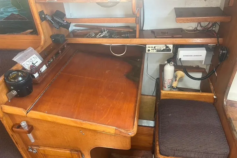 Slide: The Image of 1971 Santana 37 yacht interior with navigation desk, compass, and communication equipment. - 26