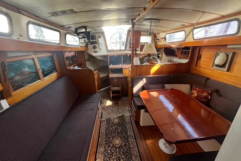 Slide: The Image of Interior of a 1971 Santana 37 sailboat with cozy seating and wooden accents. - 29