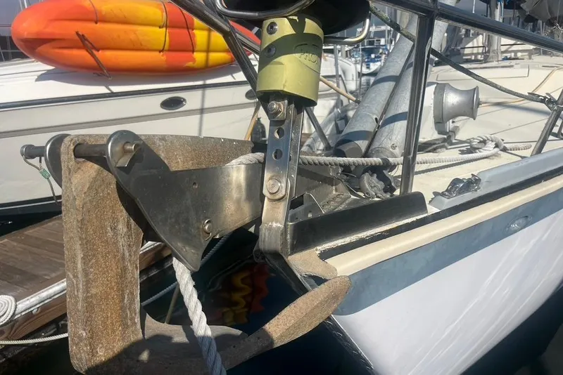 Slide: The Image of Close-up of a 1971 Santana 37 sailboat anchor and bow details at a marina. - 3