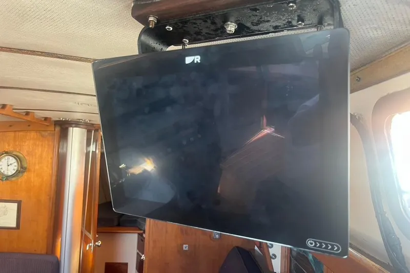 Slide: The Image of Mounted TV inside 1971 Santana 37 yacht cabin with wooden interior and nautical decor. - 31