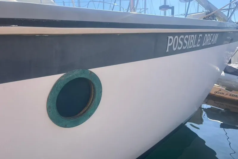 Slide: The Image of 1971 Santana 37 sailboat named "Possible Dream" docked in a marina. - 4