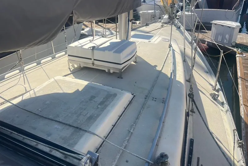 Slide: The Image of 1971 Santana 37 sailboat deck with rigging and equipment at a marina. - 5