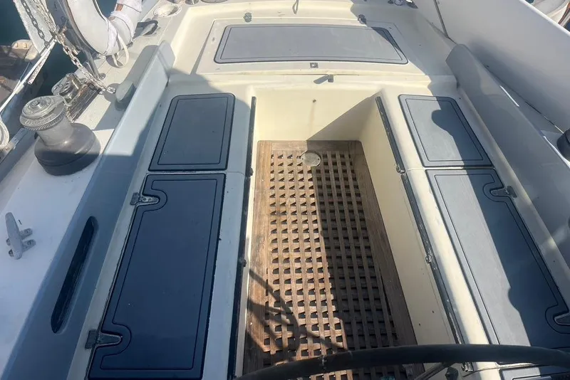 Slide: The Image of 1971 Santana 37 sailboat cockpit with storage compartments and wooden flooring. - 7