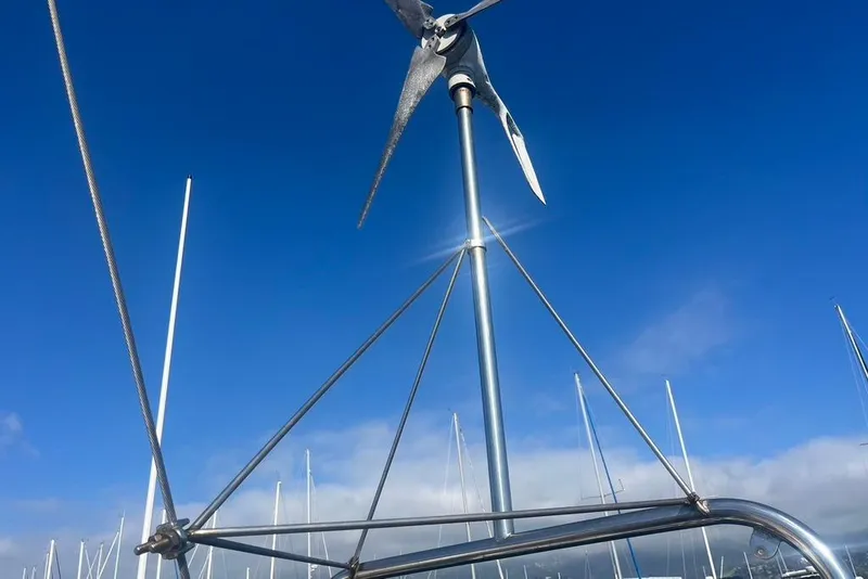 Slide: The Image of Wind turbine on Santana 37 sailboat, 1971 model, against clear blue sky. - 8