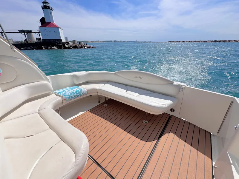 Slide: The Image of 1999 Sea Ray 38 Sundancer yacht with lighthouse in background. - 10