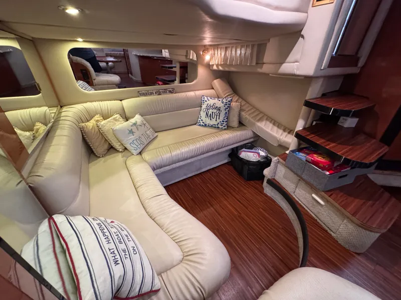 Slide: The Image of Interior of 1999 Sea Ray 38 Sundancer with beige sofa and cushions. - 19