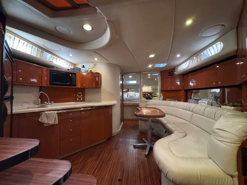 Slide: The Image of Interior of a 1999 Sea Ray 38 Sundancer yacht with elegant kitchen and seating area. - 20