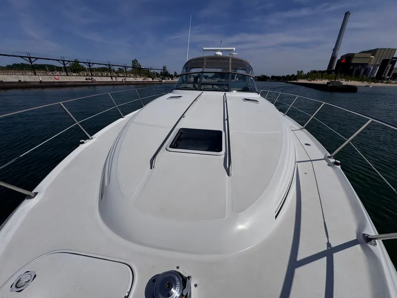 Slide: The Image of 1999 Sea Ray 38 Sundancer on calm water, front deck view. - 5