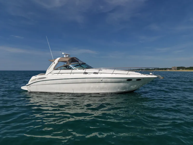 Slide: The Image of 1999 Sea Ray 38 Sundancer on open sea under clear sky. - 7