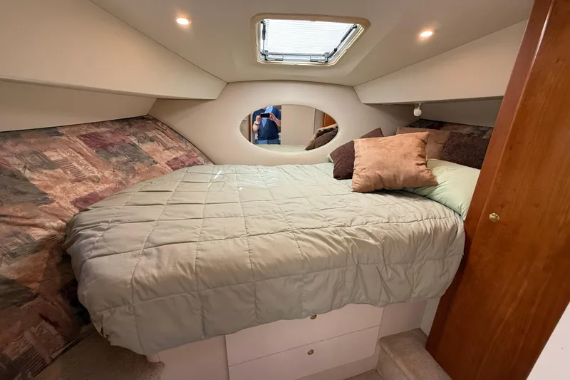 Slide: The Image of Cozy bedroom in 1999 Silverton 322 Motor Yacht with plush bedding and soft lighting. - 13