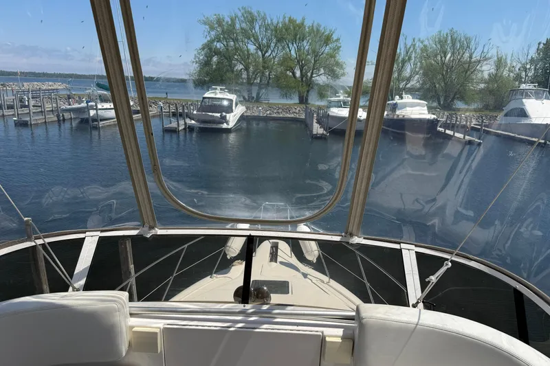 Slide: The Image of 1999 Silverton 322 Motor Yacht docked in a serene marina setting. - 19