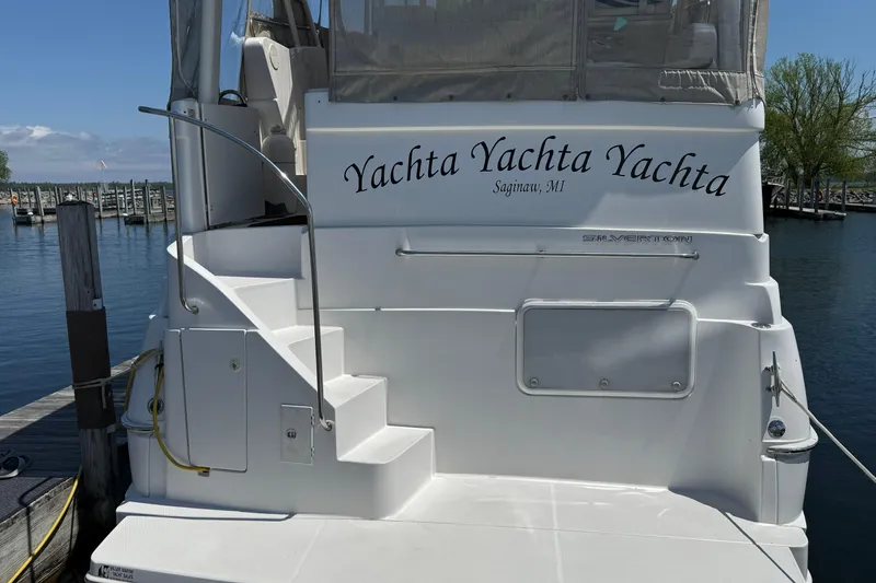 Slide: The Image of 1999 Silverton 322 Motor Yacht docked, featuring "Yachta Yachta Yachta" name, Saginaw, MI. - 20