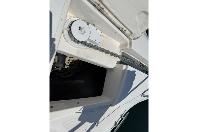 Slide: The Image of Anchor chain compartment on a 1999 Silverton 322 Motor Yacht, featuring a windlass system. - 21