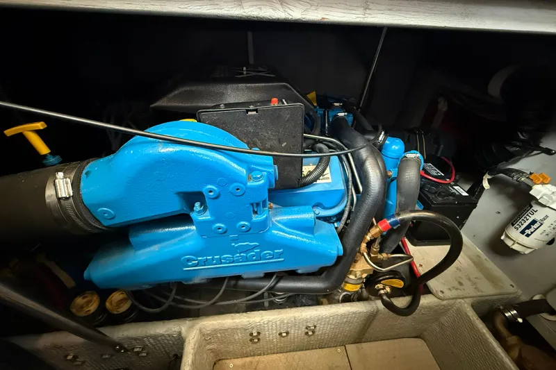 Slide: The Image of Engine compartment of a 1999 Silverton 322 Motor Yacht with a blue Crusader engine. - 23